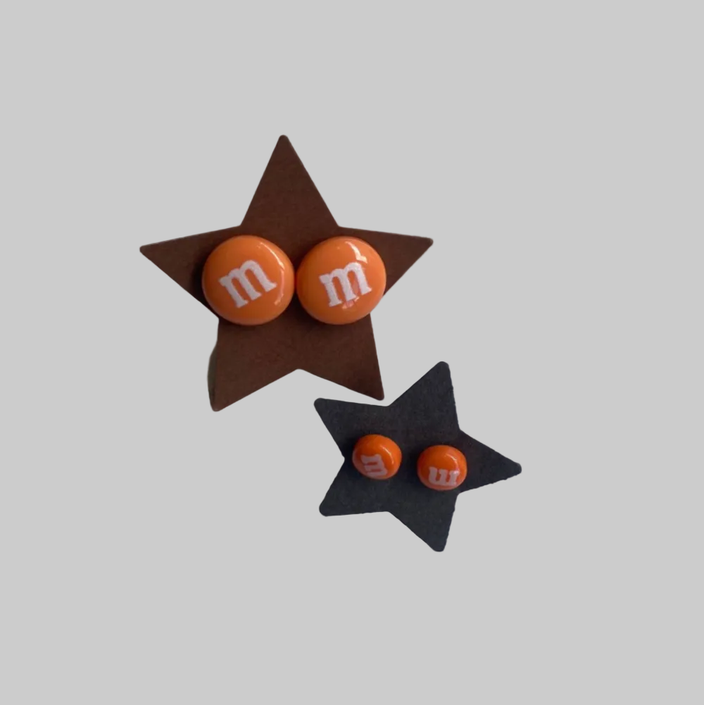 Zap Design / Ørestikker / M&M´s / Orange.
Zap Design ørestikker med orange M&M detaljer.